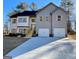 Two-story house with gray siding, white accents, and a three-car garage at 3279 Greenhill Dr, Villa Rica, GA 30180