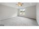 Spacious bedroom with ceiling fan and neutral carpeting at 5260 Shirewick Dr, Lithonia, GA 30058