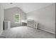 Bright bedroom with grey carpet and loft-style ceiling at 5260 Shirewick Dr, Lithonia, GA 30058