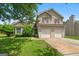 Two-story house with a two-car garage and well-maintained lawn at 5260 Shirewick Dr, Lithonia, GA 30058