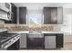 Kitchen with stainless steel sink, gas range, and dark cabinets at 5260 Shirewick Dr, Lithonia, GA 30058