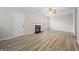 Living room with fireplace and wood-look flooring at 5260 Shirewick Dr, Lithonia, GA 30058