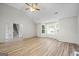 Living room with hardwood floors, bay window, and access to stairs at 5260 Shirewick Dr, Lithonia, GA 30058