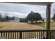 View of backyard with tennis court and trees from deck at 7019 Blue Sky Dr, Locust Grove, GA 30248