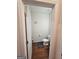 Small powder room with wood floor and white toilet at 7019 Blue Sky Dr, Locust Grove, GA 30248