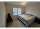 Spacious bedroom with large window and carpeted floor at 7019 Blue Sky Dr, Locust Grove, GA 30248