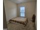 Cozy bedroom with floral bedding and a window at 7019 Blue Sky Dr, Locust Grove, GA 30248