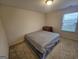 Cozy bedroom with a double bed and a window with blinds at 7019 Blue Sky Dr, Locust Grove, GA 30248