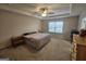 Main bedroom with ceiling fan, large bed, and dresser at 7019 Blue Sky Dr, Locust Grove, GA 30248