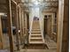 Unfinished basement with wooden stairs and framing at 7019 Blue Sky Dr, Locust Grove, GA 30248