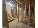 Unfinished basement with wooden framing and stairs at 7019 Blue Sky Dr, Locust Grove, GA 30248