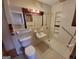 Bathroom with toilet, sink, shower, and grab bars at 213 Whippoorwill Way, Riverdale, GA 30274