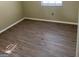 Bedroom with wood-look floors and a window at 213 Whippoorwill Way, Riverdale, GA 30274