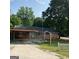 Brick ranch house with carport, mature trees, and a spacious yard at 213 Whippoorwill Way, Riverdale, GA 30274