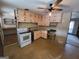 Kitchen with pink cabinets, white appliances, and a ceiling fan at 213 Whippoorwill Way, Riverdale, GA 30274