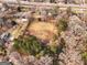 Aerial view of property, showing land and nearby houses at 60 N East Main St, Hampton, GA 30228