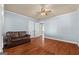 Bedroom with hardwood floors, light blue walls, and a brown couch at 60 N East Main St, Hampton, GA 30228