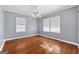 Bright bedroom with hardwood floors and ceiling fan at 60 N East Main St, Hampton, GA 30228