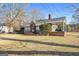 Gray house with brick details, covered porch, and expansive yard at 60 N East Main St, Hampton, GA 30228