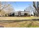 Gray house with brick accents, covered porch, and large yard at 60 N East Main St, Hampton, GA 30228