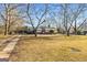 House with gray siding, covered porch, and spacious yard at 60 N East Main St, Hampton, GA 30228