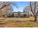 Gray house with brick accents, covered porch, and large yard at 60 N East Main St, Hampton, GA 30228