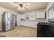 Kitchen with white cabinets, stainless steel appliances, and tile floors at 60 N East Main St, Hampton, GA 30228