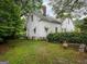 Side view of a white house with mature trees at 192 Cloud St, Jonesboro, GA 30236