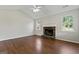 Living room with stone fireplace and hardwood floors at 217 Crystal Ct, Hampton, GA 30228