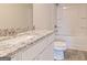 Clean bathroom with granite countertop, white cabinets, and bathtub at 760 Great Oak Pl # 22, Villa Rica, GA 30180