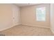 Bright bedroom with carpeted floors and large window at 760 Great Oak Pl # 22, Villa Rica, GA 30180