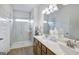 Modern bathroom featuring a glass enclosed shower, double vanity and a large mirror at 1467 Trellis Court (Lot 5), Hampton, GA 30228