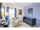 bedroom with a blue accent wall, cozy chair, robot art and black crib at 1467 Trellis Court (Lot 5), Hampton, GA 30228