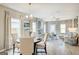 Bright dining area with a table for four, adjacent to the living room at 1467 Trellis Court (Lot 5), Hampton, GA 30228