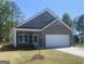 Charming single-Gathering home with a two-car garage, brick facade, and inviting front lawn at 1467 Trellis Court (Lot 5), Hampton, GA 30228