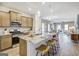 Modern kitchen with stainless appliances, granite counters, island seating, and open layout at 1467 Trellis Court (Lot 5), Hampton, GA 30228