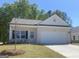 Charming single-story home with a white brick facade, manicured lawn, and attached two-car garage at 1479 Trellis Court (Lot 3), Hampton, GA 30228