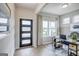 Bright foyer with modern front door, neutral walls, and a view into a home office with a large window at 1479 Trellis Court (Lot 3), Hampton, GA 30228