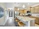 Kitchen featuring wooden cabinets, stainless steel appliances, granite counters, and a center island with breakfast bar at 1479 Trellis Court (Lot 3), Hampton, GA 30228