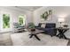 Comfortable living room with stylish seating, a rustic wood coffee table, and a soft, inviting rug at 1479 Trellis Court (Lot 3), Hampton, GA 30228
