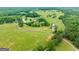 Aerial view of a home on a large lot with a silo and open fields at 241 Hosannah Rd, Locust Grove, GA 30248