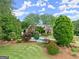 Brick home with lush landscaping and a view of the pool area at 241 Hosannah Rd, Locust Grove, GA 30248