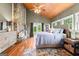 Main bedroom with king-size bed, fireplace, and hardwood floors at 241 Hosannah Rd, Locust Grove, GA 30248