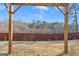 Expansive backyard with a wooden pergola, lush trees, and a privacy fence at 5626 Wyncreek Sw Cir, South Fulton, GA 30331