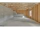 Unfinished basement with concrete walls, wooden framing, and a window, ready for customization at 5626 Wyncreek Sw Cir, South Fulton, GA 30331