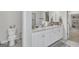 Bright bathroom featuring double sinks, granite countertops, walk-in closet, marble tile floors, and white cabinetry at 5626 Wyncreek Sw Cir, South Fulton, GA 30331