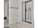 Well-lit bathroom showcasing a walk-in shower with marble surround, bronze trim, and marble floors at 5626 Wyncreek Sw Cir, South Fulton, GA 30331