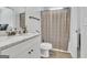 Bathroom with a vanity and granite countertop, shower with neutral tone curtain at 5626 Wyncreek Sw Cir, South Fulton, GA 30331