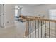 Second floor hallway with decorative railing, plush carpet, and access to living room at 5626 Wyncreek Sw Cir, South Fulton, GA 30331
