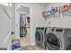 Bright laundry room featuring a large capacity washer and dryer, and shelving at 5626 Wyncreek Sw Cir, South Fulton, GA 30331